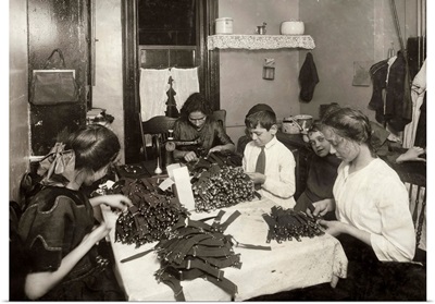 A Jewish family making garters in their tenement home in New York City, 1912