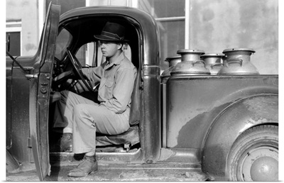 A man waiting to unload milk cans at a creamery in San Angelo, Texas, 1939