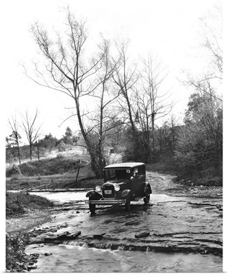 A Model A Ford crossing a creek bed in Oldham County, Kentucky, 1930