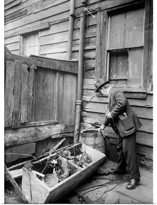 A public health inspector identifying mosquito breeding areas, 1910