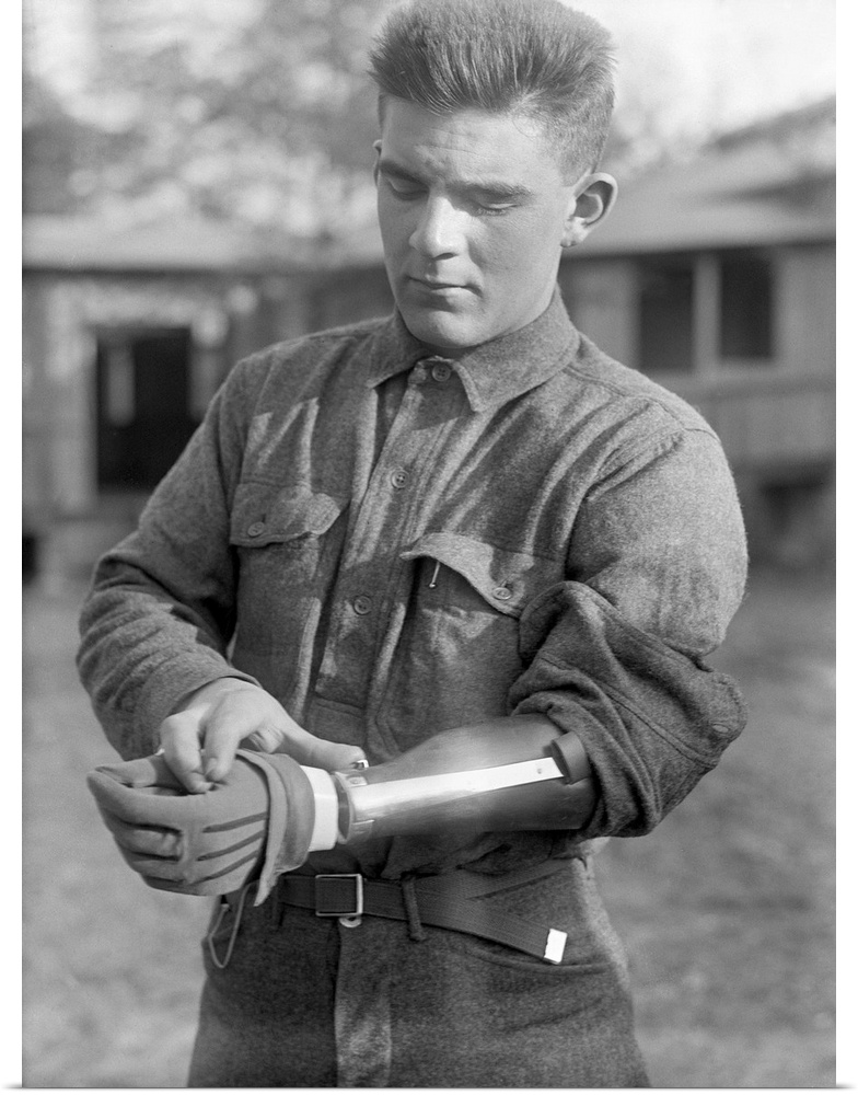 A veteran of World War I wearing a prosthetic arm, possibly at Walter Reed Hospital in Washington, D.C. Photograph, c1917.