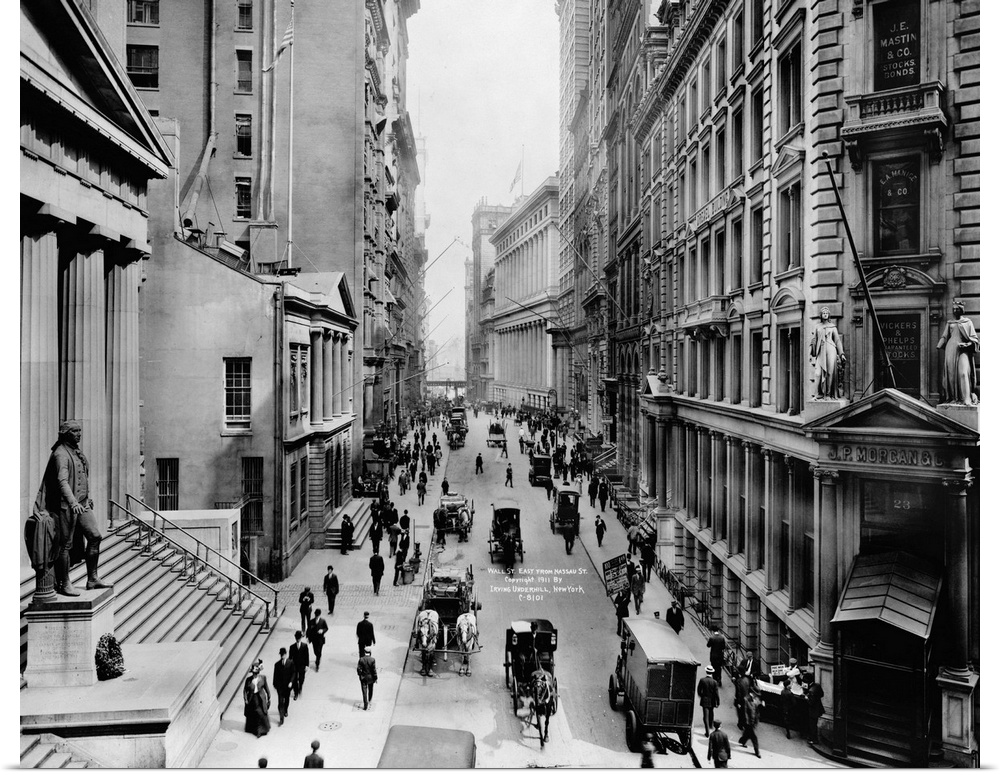 A view down Wall Street from Nassau Street in New York City. Photograph, c1911.