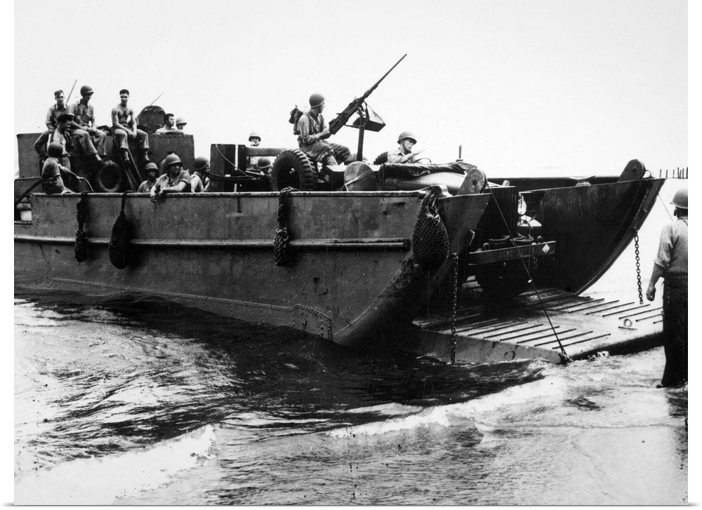 An American landing craft dropping its ramp on the beach at Guadalcanal in the Solomon Islands, as the U.S. Marine reconna...
