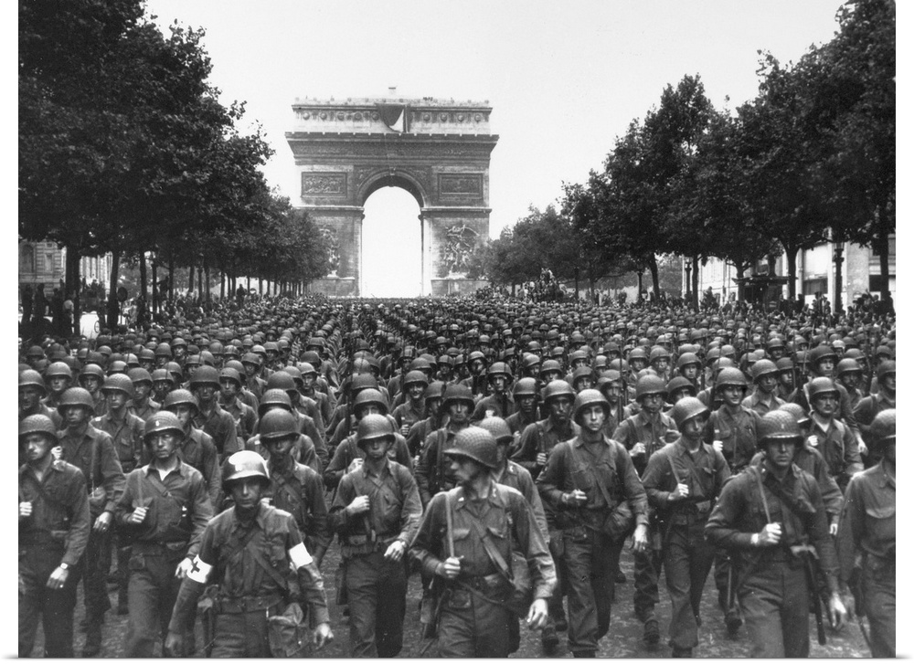 American troops marching on the Avenue des Champs-?lys?es in Paris, France, with the Arc de Triomphe in the background. Ph...