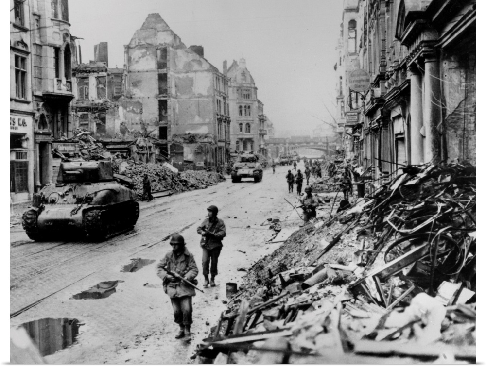 American troops on patrol through the ruins of Cologne, Germany. Photograph, 1945.