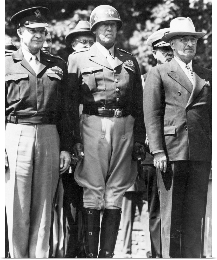 General Dwight D. Eisenhower, General George S. Patton, and President Harry S. Truman watching as the American flag is rai...