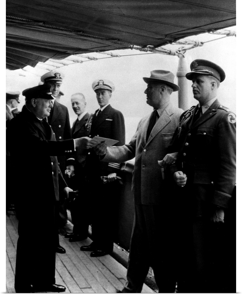 Prime Minister Winston Churchill and President Franklin D. Roosevelt (exchanging document) aboard the HMS 'Prince of Wales...