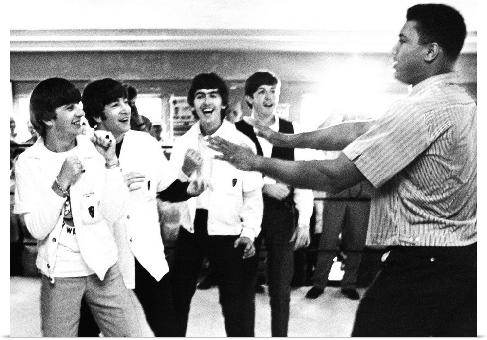 The Beatles (from left: Ringo Starr, John Lennon, George Harrison, and Paul McCartney) clowning with boxer Cassius Clay (l...