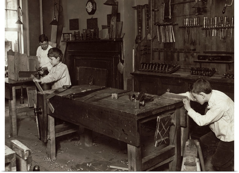 Boys learning carpentry in a woodwork shop class at the Henry St. Settlement in New York City. Photograph by Lewis Hine, M...