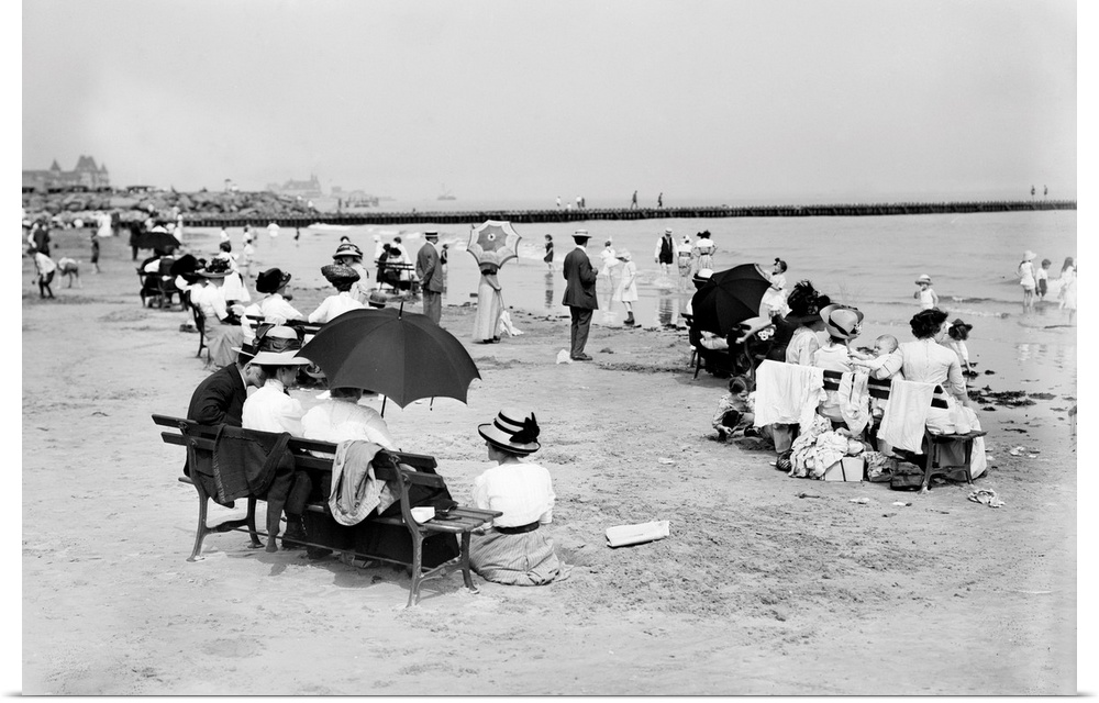 People seated on park benches by the seashore at Coney Island, Brooklyn, New York. Photograph, c1910.