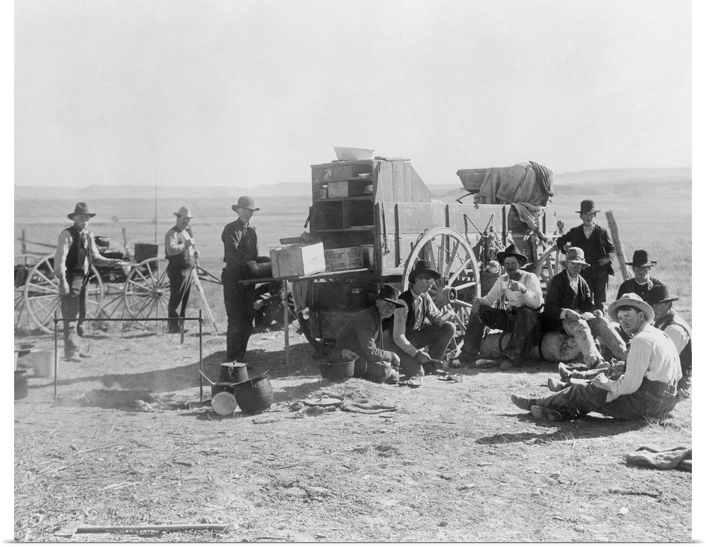 Cowboy Camp, C1900. A Group Of Cowboys Sitting And Standing Beside A Chuckwagon At A Campsite Near Barela, Colorado. Photo...