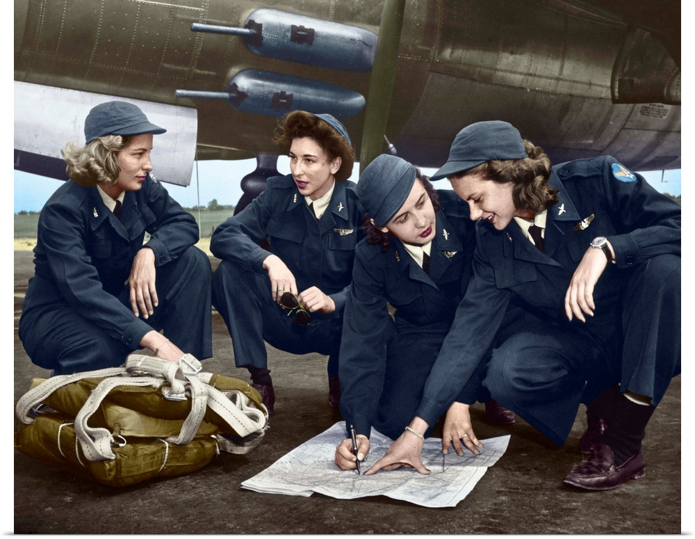 Four female pilots looking at a chart. Photograph, c1941, digitally colored by The Granger Collection.
