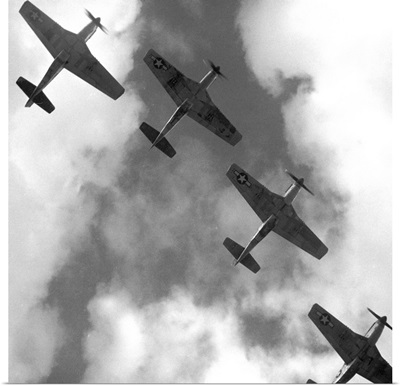 Four P-51 Mustang fighter planes flying in formation over Ramitelli, Italy, 1945