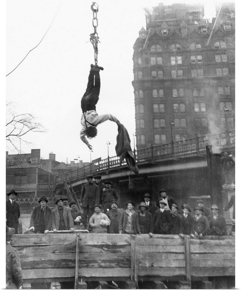 American magician. Houdini escaping from his straitjacket while suspended during a midair stunt in 1916.