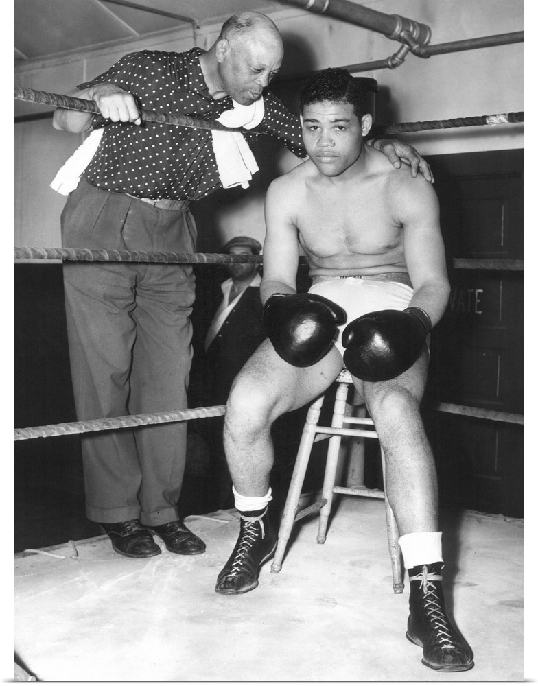 American heavyweight pugilist. In training camp at Pompton Lakes, New York, 4 June 1938, with his trainer Jack Blackburn.