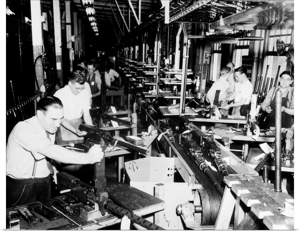 Men working on machine guns on the assembly line at the General Motors plant in Detroit, Michigan. Photograph, 1942.