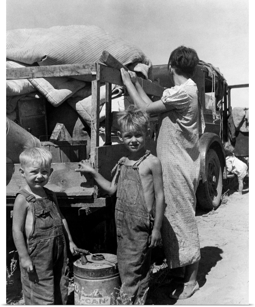 Part of an impoverished homeless family of nine on a New Mexico highway, preparing to sell their belongings for money to b...