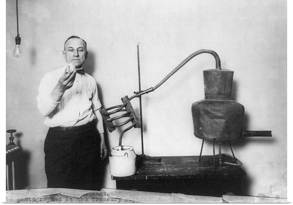 Man with a confiscated moonshine distillery, photographed at the Treasury in Washington, D.C., during Prohibition, 1920s.