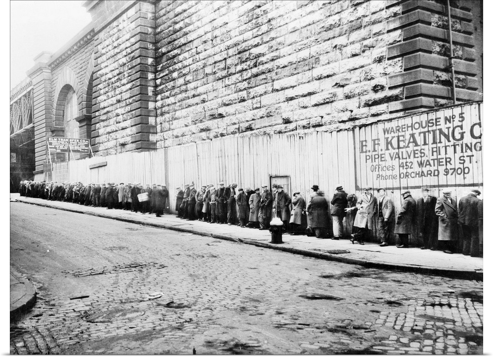 Unemployed workers in a New York City bread line beside the Brooklyn Bridge approach. Photograph, c1930-1935.