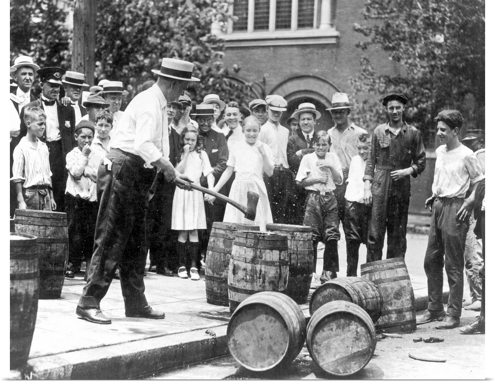 Federal agent destroying contraband kegs of alcohol in Chicago during the 1920s.