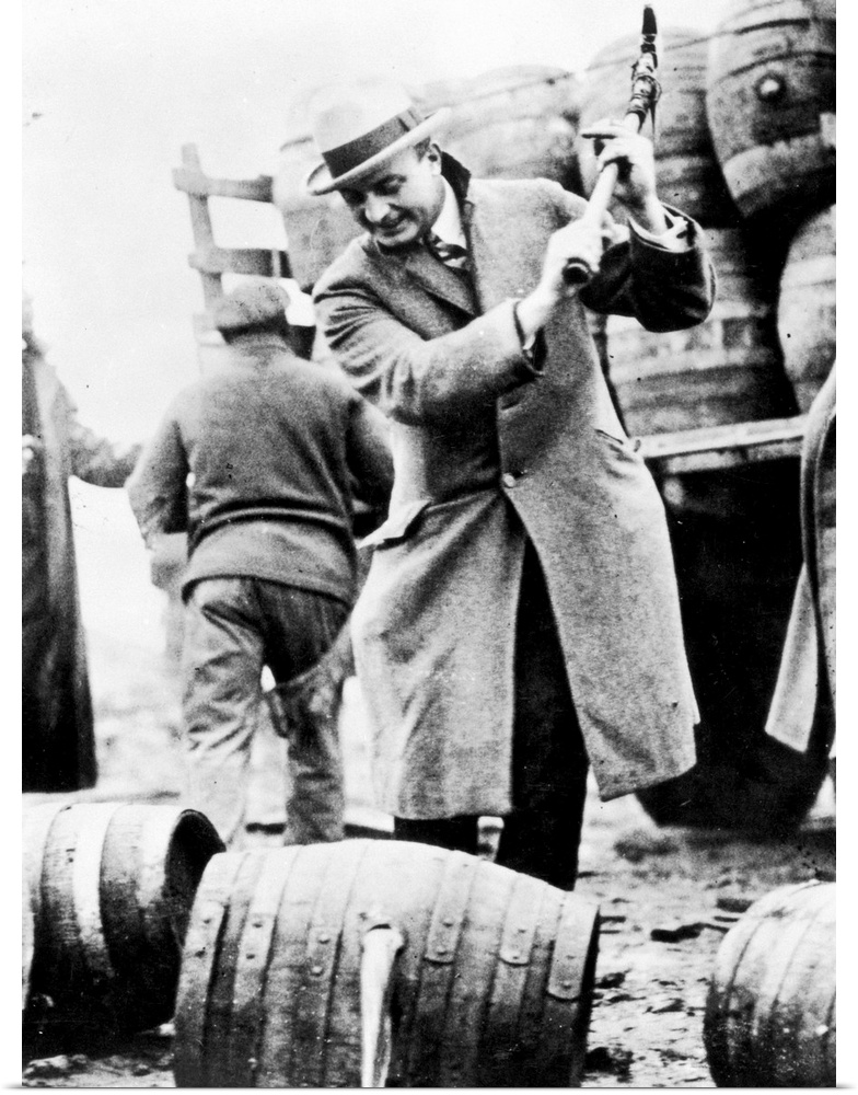 Philadelphia public safety director Butler destryoing contraband kegs of bootleg beer, the contents of which had been pour...