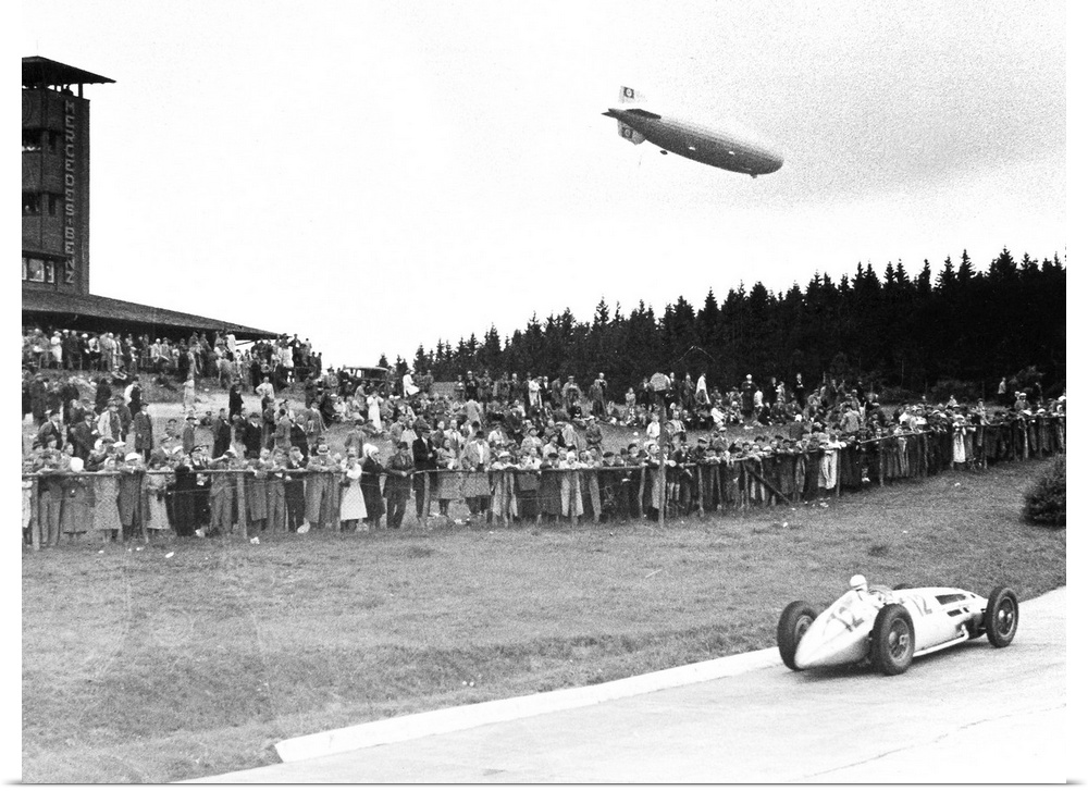 (1901-1958). German racing driver. The airship Graf Zeppelin hovers above the crowd at Nuremberg, Germany, as Caracciola w...
