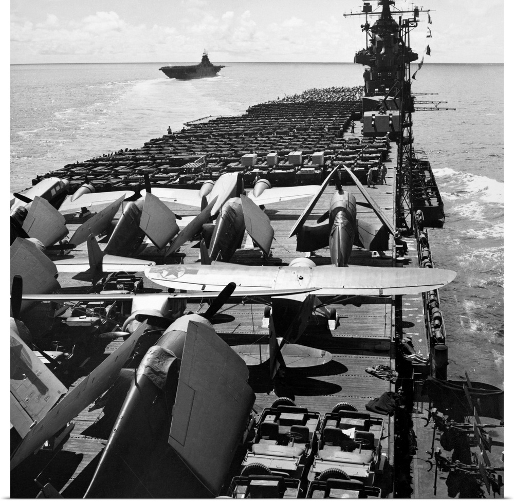 The USS Yorktown aircraft carrier ferries planes and jeeps to battle fronts in the Pacific. Photograph, September 1943.