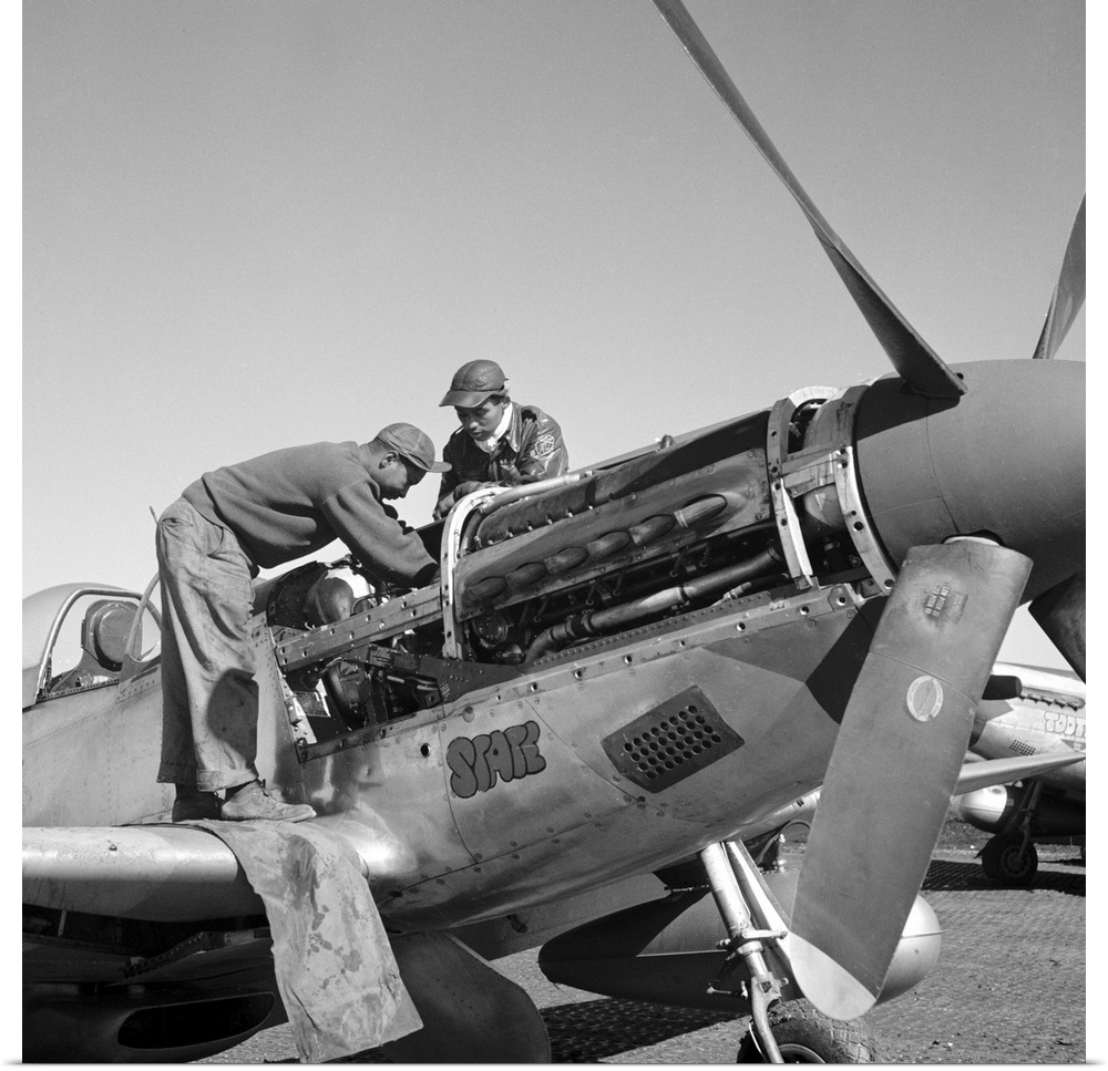 Tuskegee Airmen mechanics Marcellus Smith (left) and Roscoe Brown, working on a fighter plane at Ramitelli Airfield, Italy...
