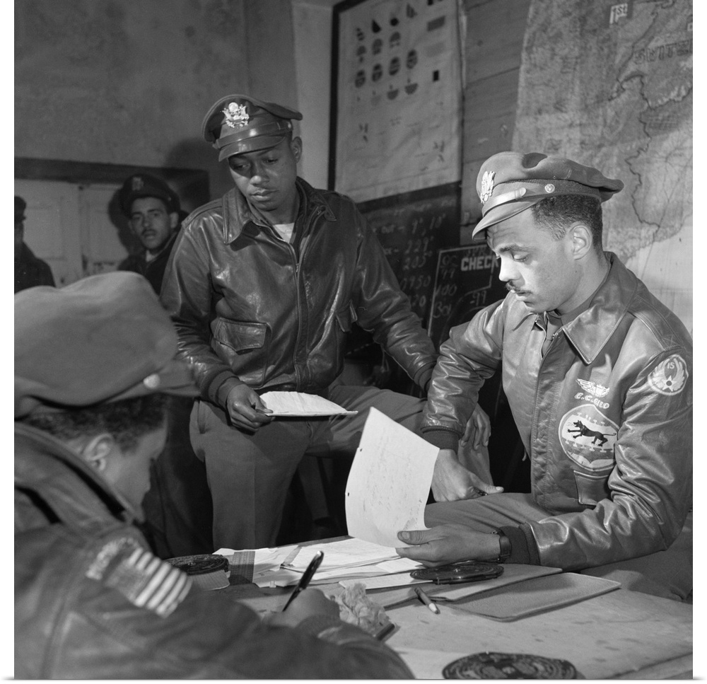 Tuskegee Airmen Woodrow Crockett (standing) with Group Operations Officer Edward Gleed at Ramitelli Airfield in Italy. Pho...