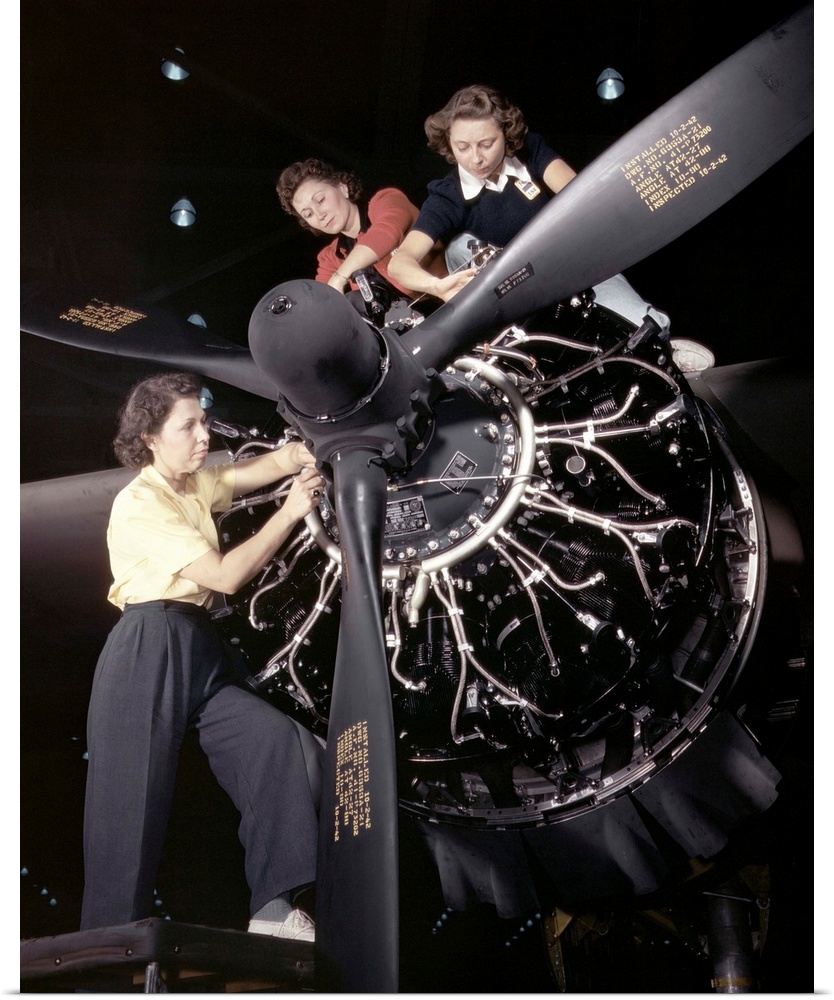 Women installing an aircraft engine at the Douglas Aircraft plant in Long Beach, California. Photograph by Alfred T. Palme...