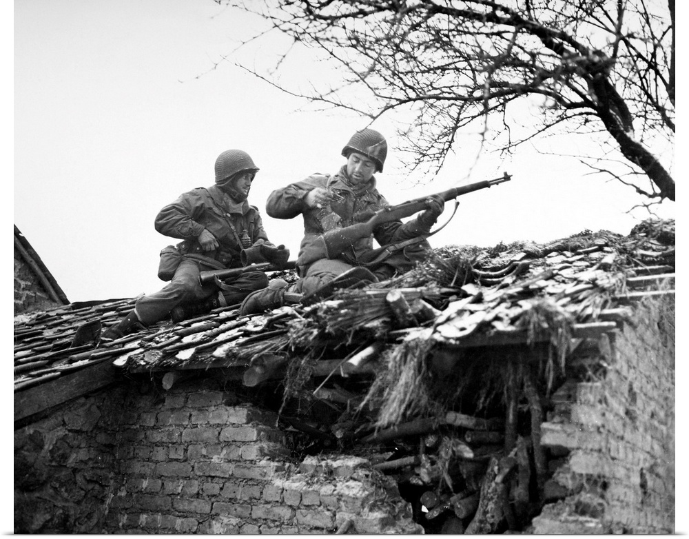 American rifleman on a rooftop in Beffe, Belgium, snipe German snipers. Photographed 7 January 1945.