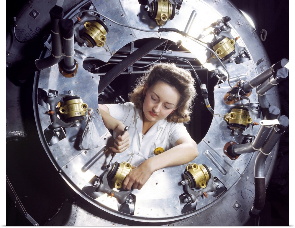 A woman working on a motor for a B-25 bomber at the North American Aviation plant in Inglewood, California. Photograph by ...