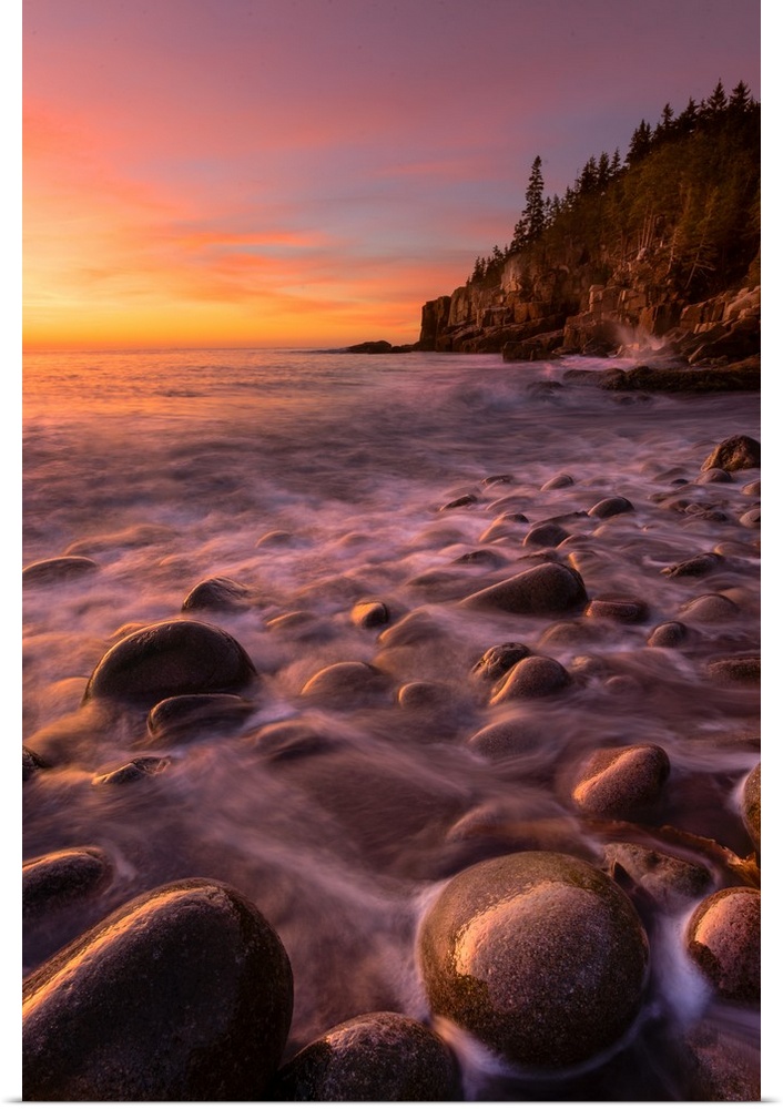 Low tide over smooth round stones on the beach in Acadia National Park, Maine.