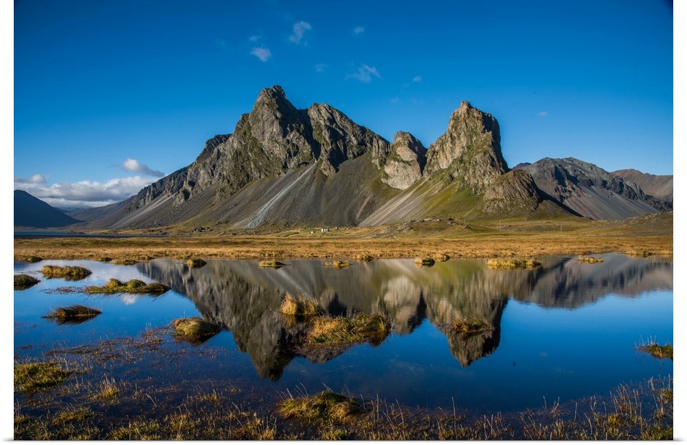 Rugged mountains in Iceland, reflected in the clear lake below.