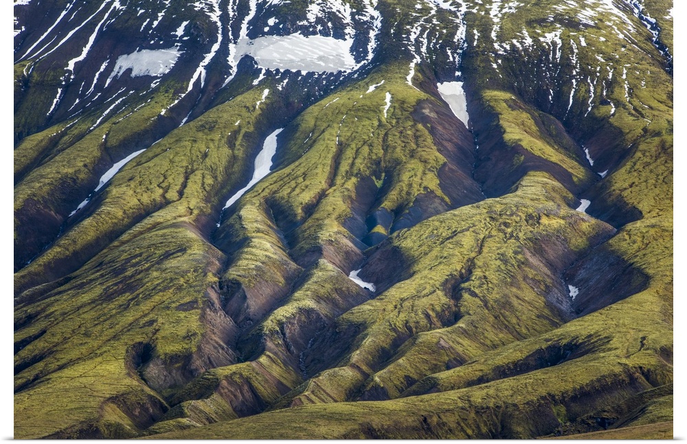 Deep rifts in the mountain landscape formed by years of glacial erosion, seen in an aerial view of Iceland.