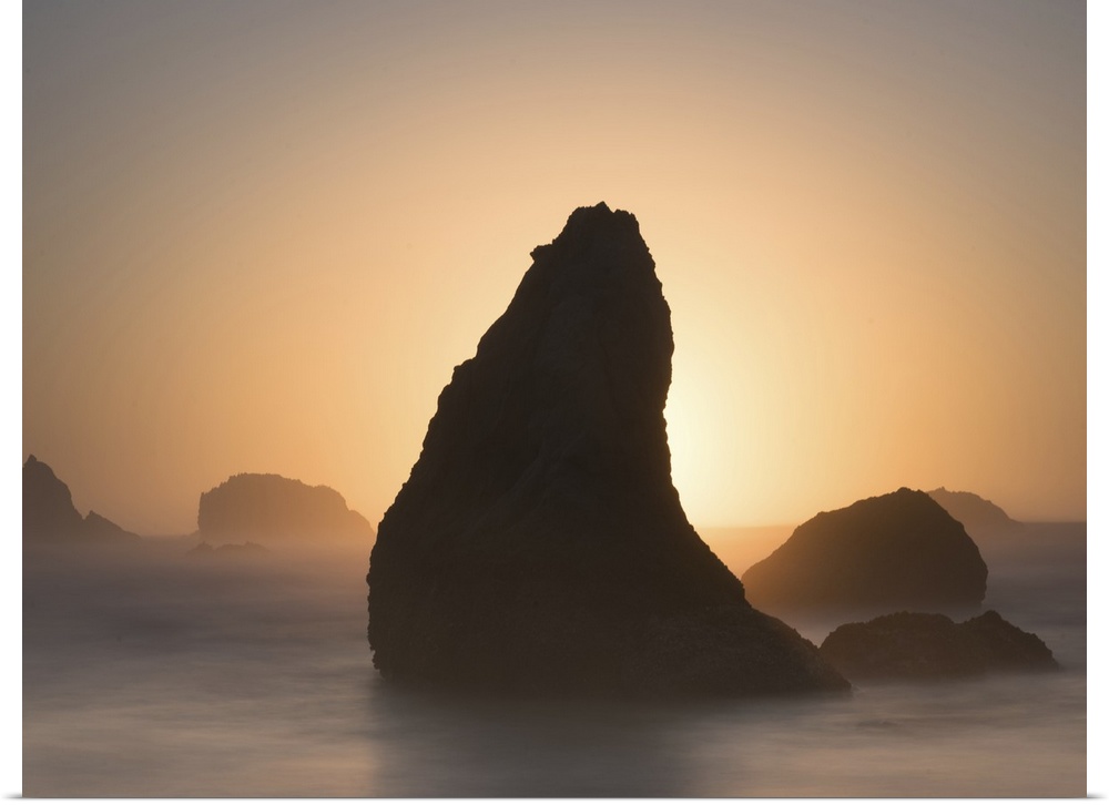 Pointed sea stack in the misty ocean in the morning, Bandon, Oregon.