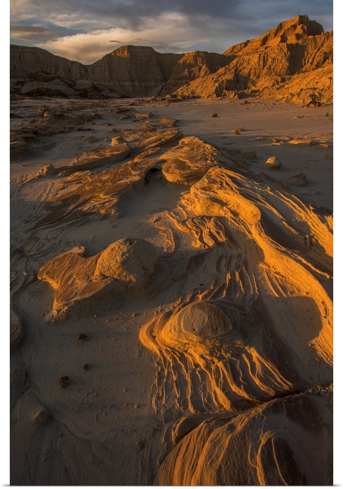Eroded rocks in the South Dakota Badlands in warm light from the sunset.