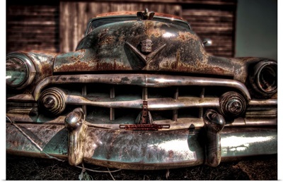 A 1950's American Cadilac car with rust and chrome bumper