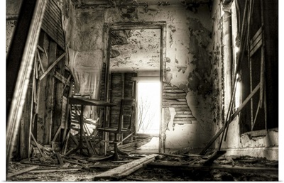 A derelict interior with peeling plaster and broken walls