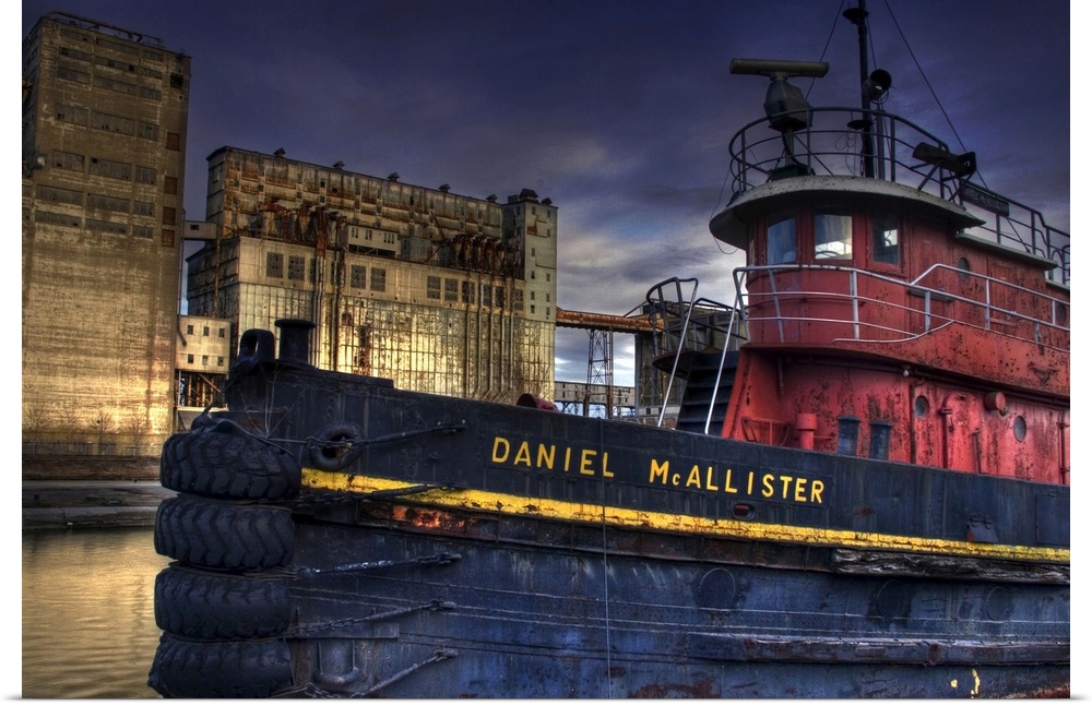 An old tug boat near to industrial buildings