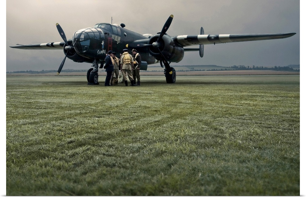 A B-25 Mitchell bomber and crew at dawn