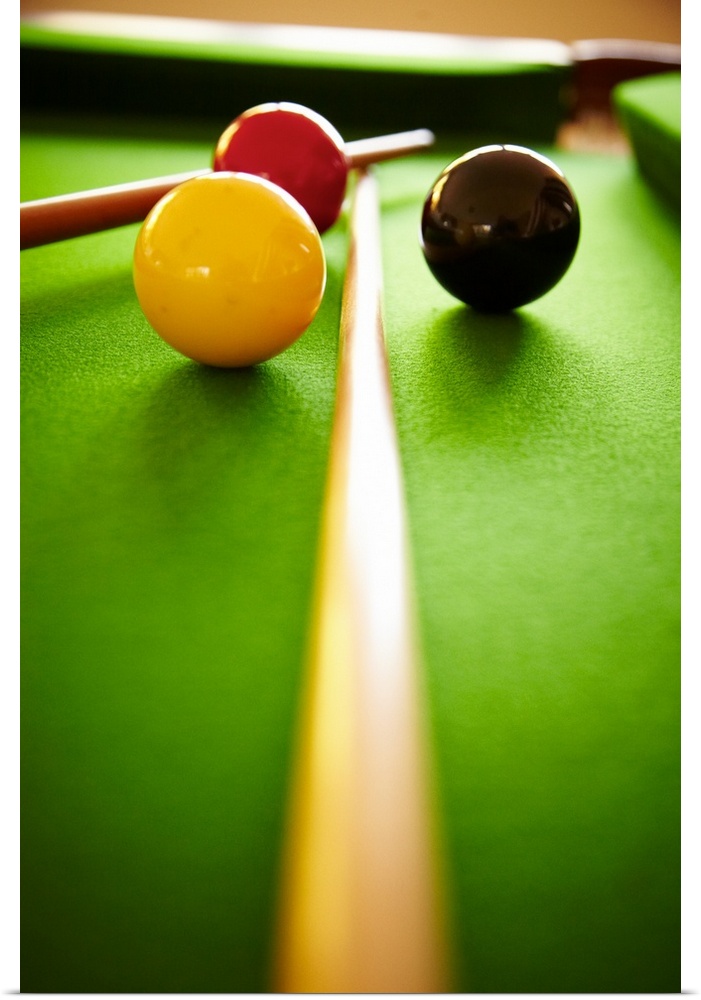 red white and black billiard balls on green baize