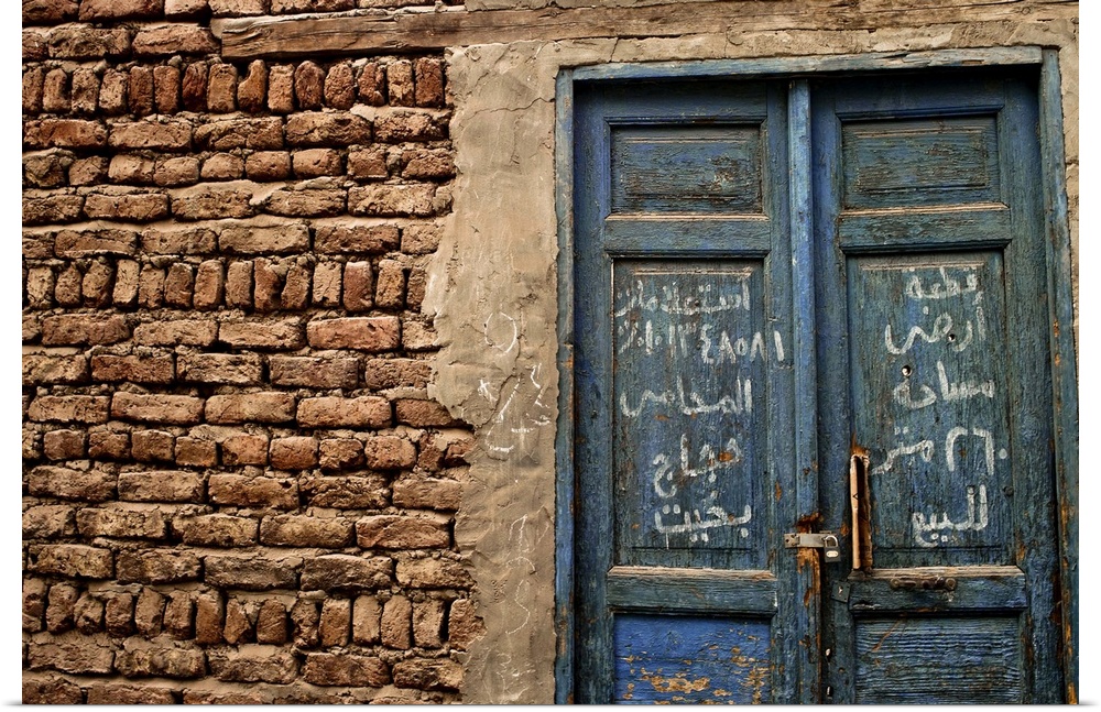 A blue door with Arabic writing, Luxor town, Egypt.