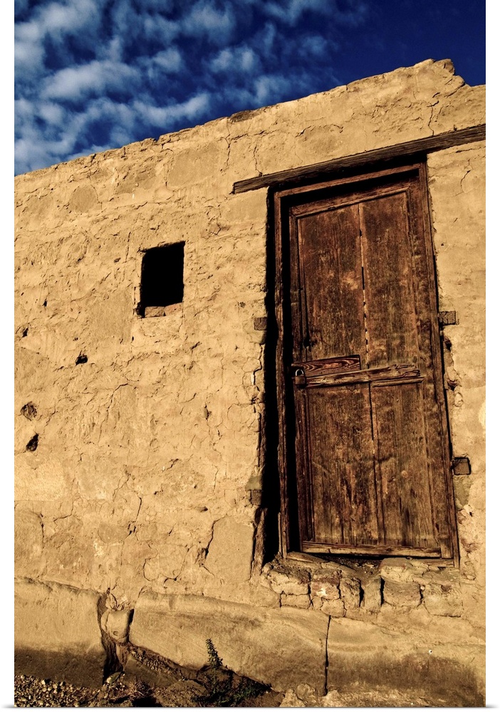 Brown wooden door with blue sky and clouds, Karnak, Egypt