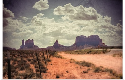 Large monolithic rocks in the background looking through Monument Valley III