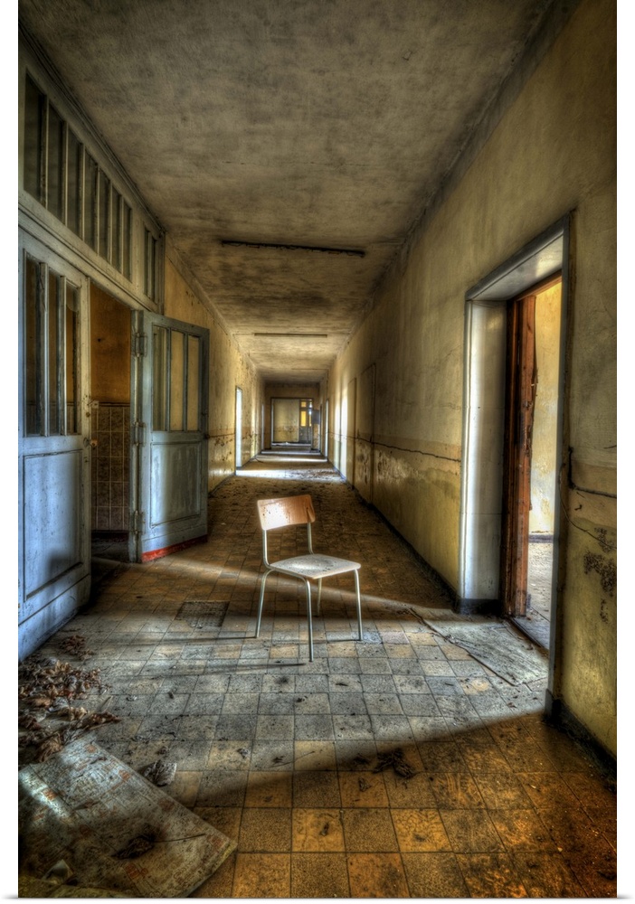 Interior of decaying old tanks barracks somewhere near Berlin with chair in corridor and sunlight