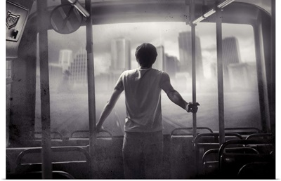 Male youth standing on bus looking out at distant city sky scrapers through haze