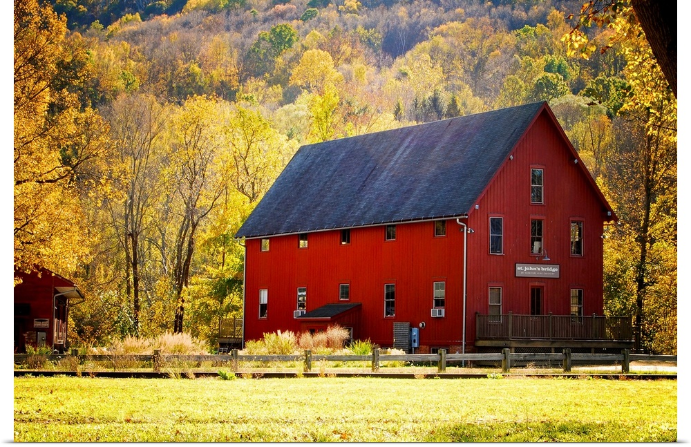 Typical red barn surrounded by vibrant autumn foliage. Kent, Connecticut.