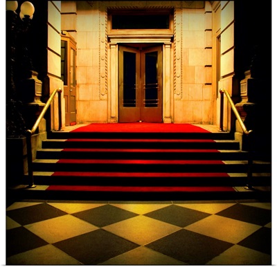 Red carpeted steps leading up into a hotel lobby
