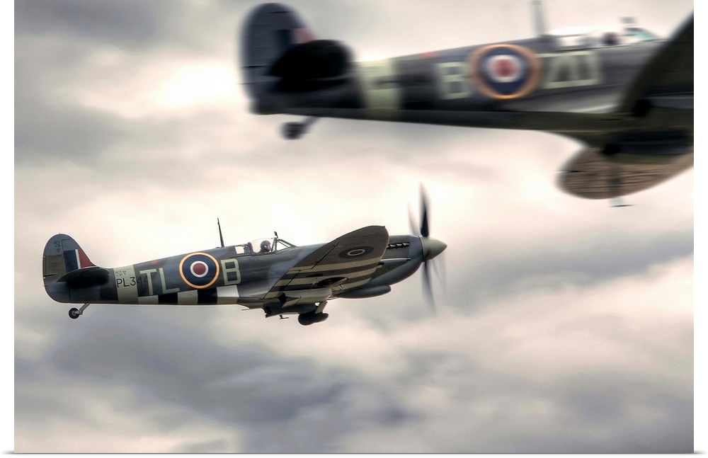 Two Spitfires scrambling to takeoff at Duxford.